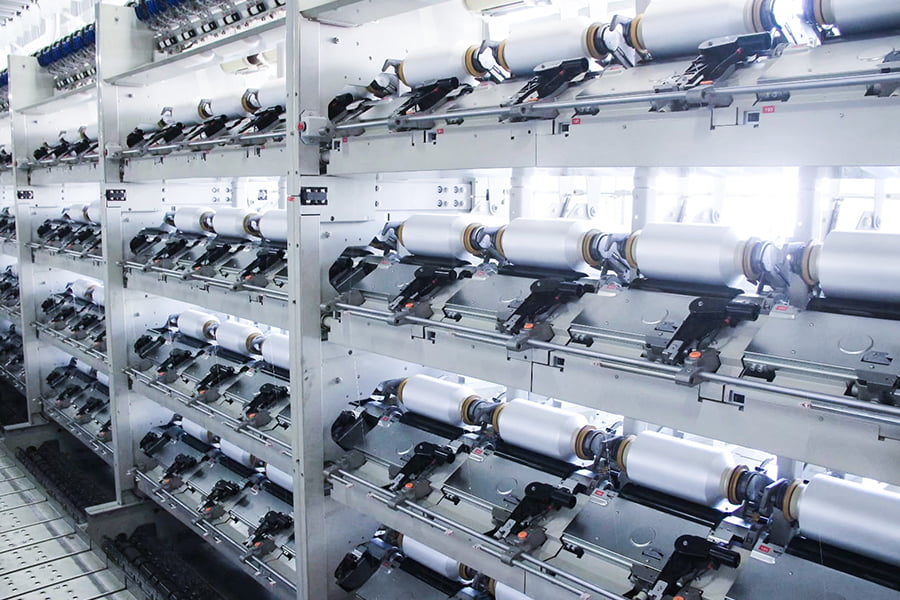 How does the production cost of FDY yarn compare to other types of yarn